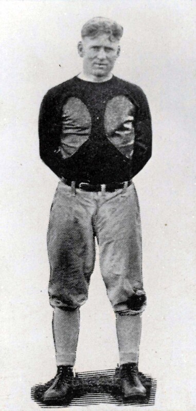 An image of Bill Zorn, standing with his hands clasped behind his back, while wearing a uniform. The background of the image is removed so the image only focuses on Coach Bill Zorn. This image appeared in the 1929 yearbook, "The Periscope," on page 107.